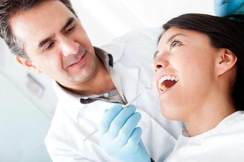 A dentist talking to a patient.