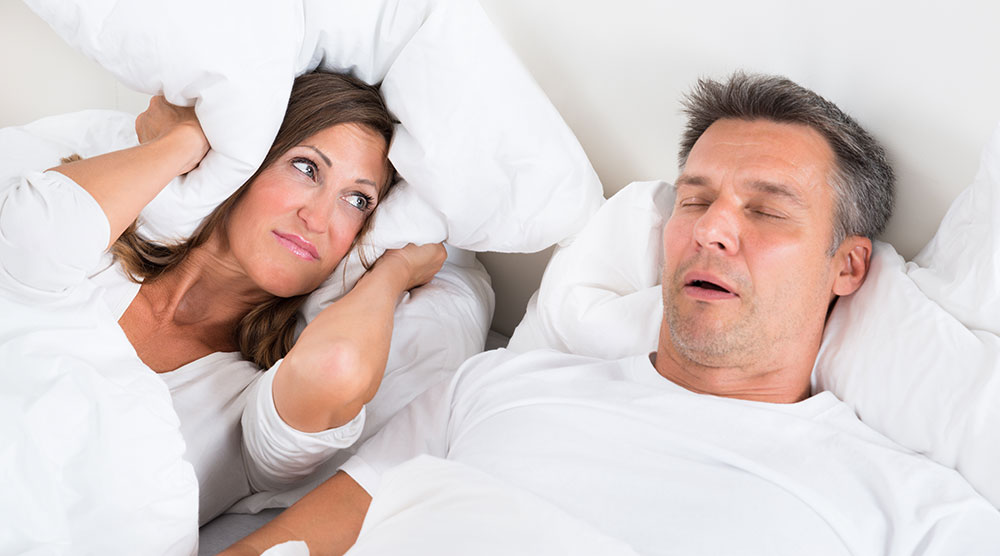 Two people in a bed sleeping.