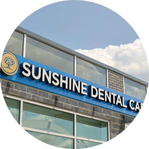 The Sunshine Dental Care logo on the outside of the office.
